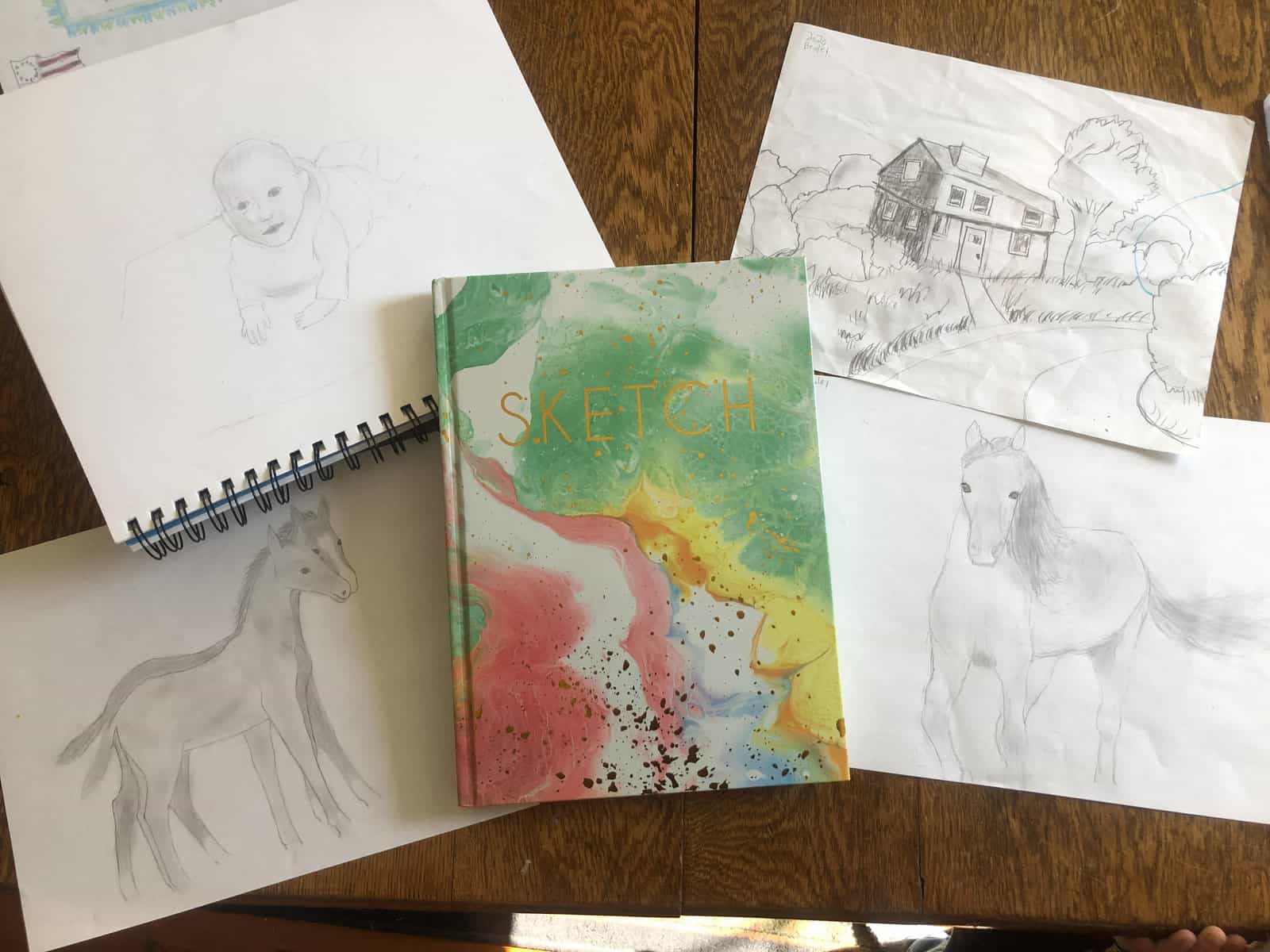 sketchbook with sketches on a table