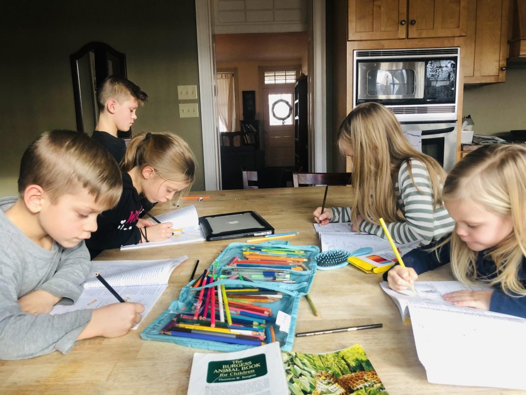 kids writing at a table